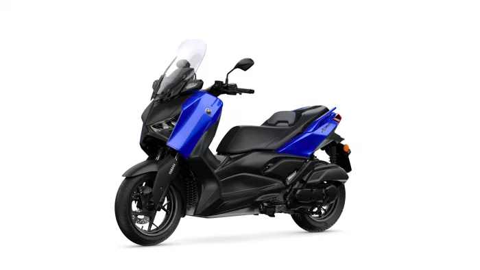 Blue Yamaha XMAX scooter shown from a three-quarter front angle with a tall windshield and black frame (isolated on white).