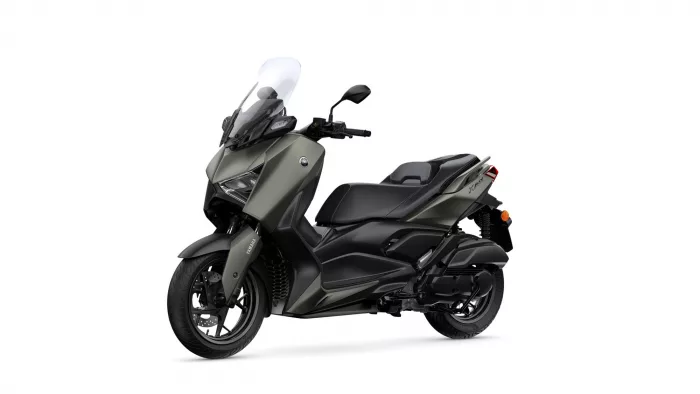 Yamaha XMAX scooter facing left with a tall windshield and olive-gray body, shown in a three-quarter front view