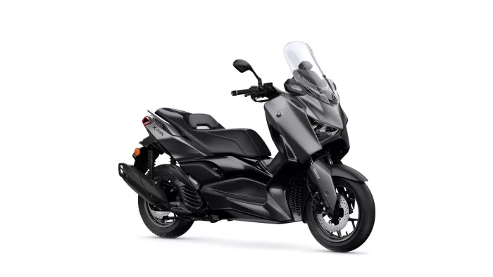 Gray and black Yamaha scooter with a tall clear windshield and contoured seat, angled to show the front and side profile