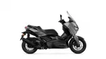 Side view of a black Yamaha XMAX sport scooter with a tall clear windshield.