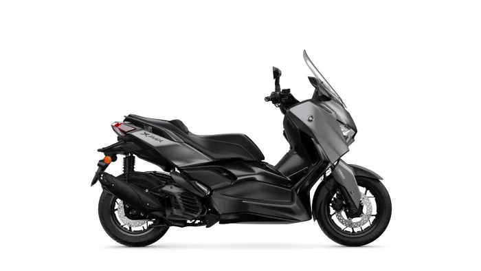 Side view of a black Yamaha XMAX sport scooter with a tall clear windshield.