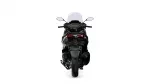 Rear view of a black sport motorcycle with a tall windshield and red taillights