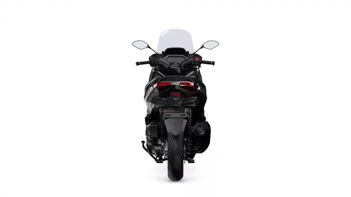 Rear view of a black sport motorcycle with a tall windshield and red taillights