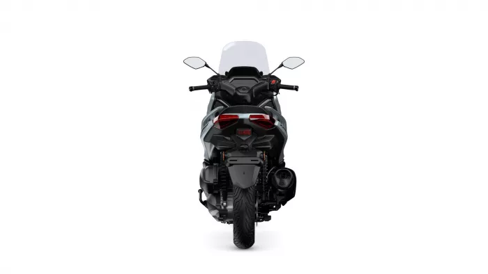 Rear view of a black sport motorcycle with a tall windshield and red taillights against a white background.