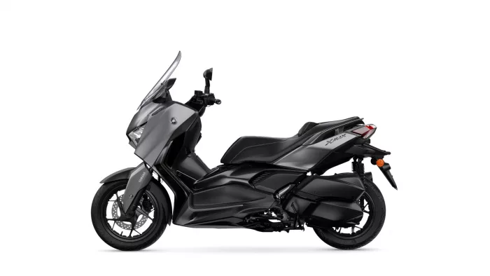 Side view of a Yamaha XMAX sport scooter in matte gray and black, showing windscreen and seating area.
