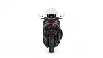 Rear view of a black sport motorcycle with a red taillight, back seat and windscreen against a white background