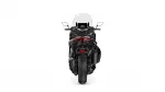 Rear view of a black sport motorcycle with a windshield and red taillight accents behind the seat.