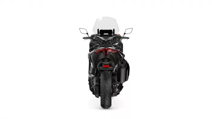 Rear view of a black sport motorcycle with a windshield and red taillight accents behind the seat.