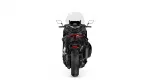Rear view of a black sport motorcycle with a tall windshield, red taillight, and wide rear tire against a white background.