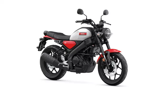Front-right view of a Yamaha motorcycle with a gray fuel tank, red accents, and black frame and exhaust components.