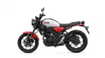 Side view of a red and black Yamaha motorcycle, showing a silver fuel tank with a Yamaha logo and a low-slung seat labeled XSR.