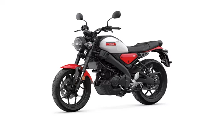 Red Yamaha motorcycle shown from a left-front side angle, with a round headlight and white fuel tank accented by red panels