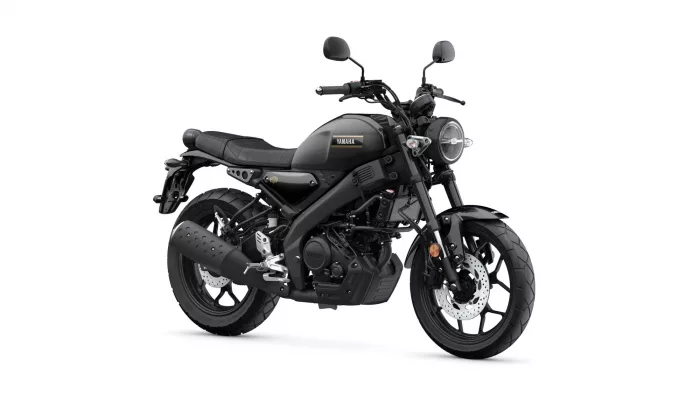 Black Yamaha motorcycle shown from a front-right angle, highlighting the round headlight and matte black finish on a white background.