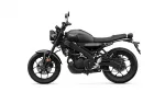 Black Yamaha motorcycle shown from the side with a low-profile seat and exposed engine, emphasizing its sporty retro design.