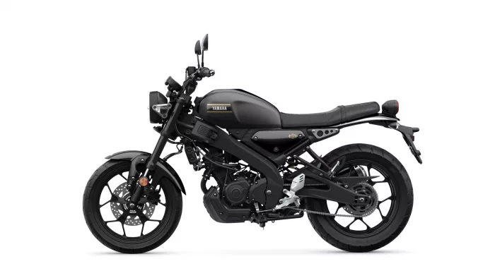 Black Yamaha motorcycle shown from the side with a low-profile seat and exposed engine, emphasizing its sporty retro design.