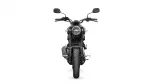 Front-on view of a black motorcycle facing the camera, showing round headlight, handlebars, and mirrors.