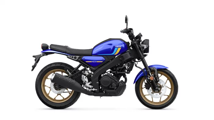 Blue Yamaha motorcycle shown in a left-side profile with black frame, gold wheels, and an exposed engine.