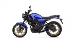 Blue Yamaha motorcycle in side view, gold alloy wheels and black frame.