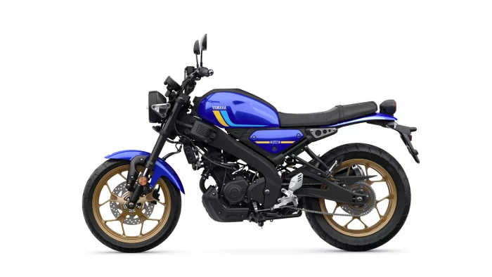 Blue Yamaha motorcycle in side view, gold alloy wheels and black frame.