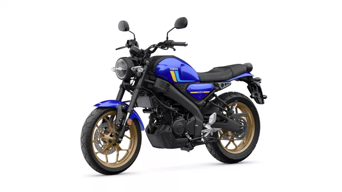 Blue Yamaha motorcycle shown from a front-left angle with a round headlight and gold wheels.