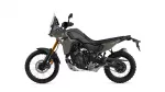 Side view of a Yamaha Tenere 700 adventure motorcycle in matte gray with a windshield, gold front forks, and knobby tires on a white background.