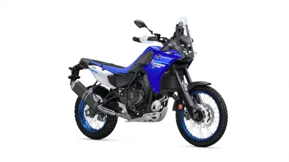 Blue Yamaha Tenere 700 dual-sport motorcycle viewed from the side, with windshield and knobby tires.