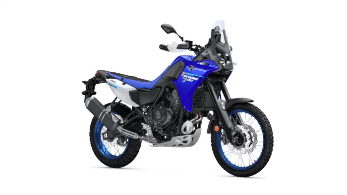 Blue Yamaha Tenere 700 dual-sport motorcycle viewed from the side, with windshield and knobby tires.