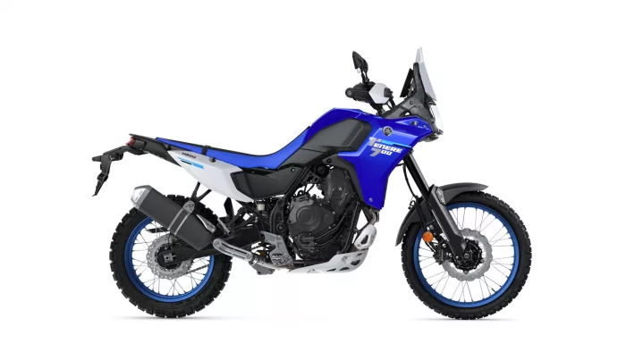 Blue Yamaha Tenere 700 adventure motorcycle shown in profile with a tall windshield and knobby off-road tires.