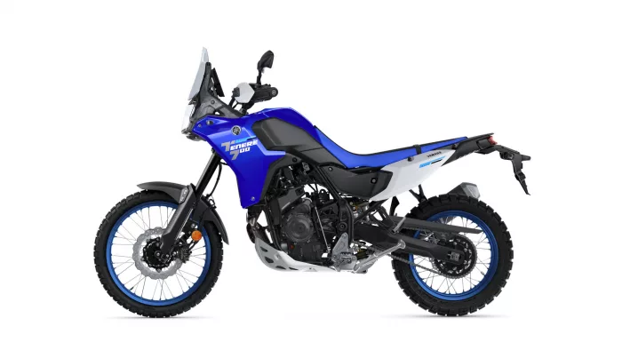 Left-side view of a blue Yamaha Tenere 700 adventure motorcycle with knobby off-road tires