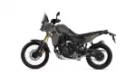 Side view of a Yamaha Tenere 700 adventure motorcycle in olive green and black, with a tall windshield and knobby off-road tires.