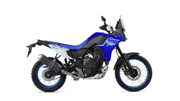 Blue Yamaha Tenere 700 adventure motorcycle pictured in side profile with knobby tires and windshield