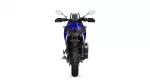 Rear view of a blue sport-t touring motorcycle, showing big rear tire, taillight, and right-side exhaust