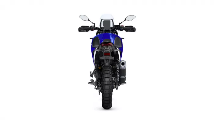 Rear view of a blue sport-t touring motorcycle, showing big rear tire, taillight, and right-side exhaust