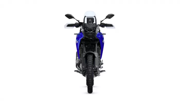 Front view of a blue adventure motorcycle with windshield and dual front headlights on a white background