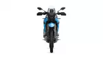 Front view of a blue adventure motorcycle with a tall windshield and dual headlights against a white background.