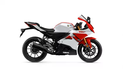 Side view of a white and red Yamaha YZF sport motorcycle with black frame and gold front forks.