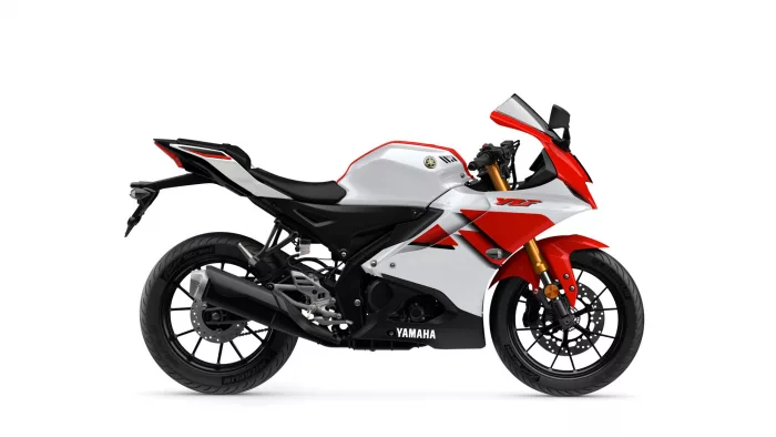 Side view of a white and red Yamaha YZF sport motorcycle with black frame and gold front forks.