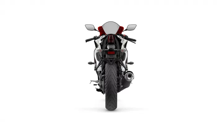 Rear view of a sport motorcycle facing the camera, showing red seat, white/black body, and visible exhaust on the right side