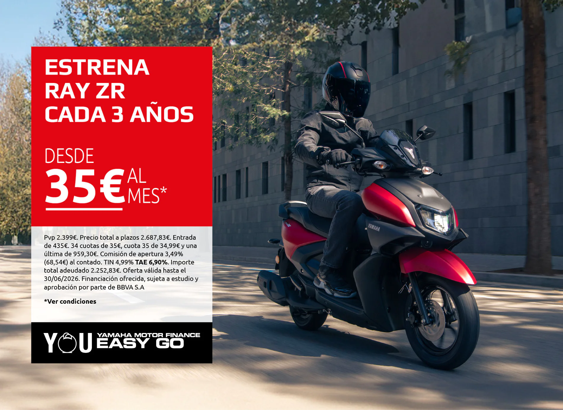 Motorcyclist on a red Yamaha bike rides past a large red advertisement banner with financing offer in Spanish.