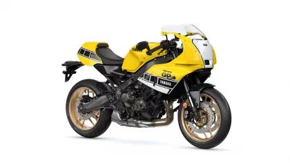Yellow Yamaha sport motorcycle shown from the side with a black frame and gold wheels on a white background, highlighting its racing design.