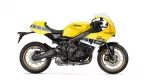 Side view of a bright yellow Yamaha XSR900 GP motorcycle, showing its black frame, gold wheels, and GP decals on the fairing.