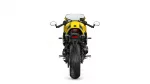 Rear view of a yellow sport motorcycle showing taillight, exhaust, and wide rear tire