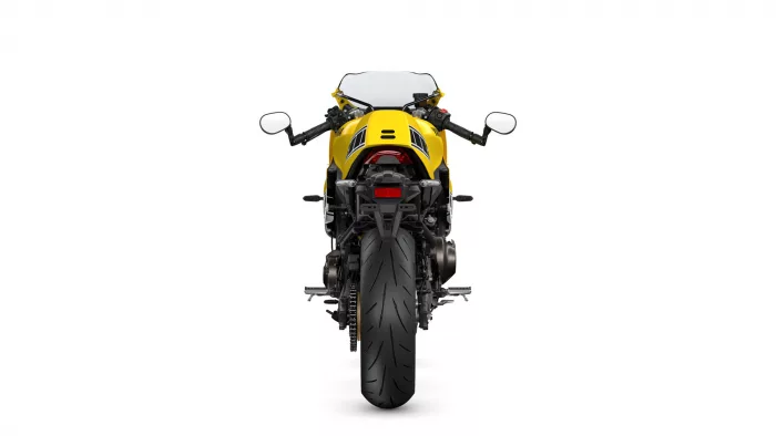 Rear view of a yellow sport motorcycle showing taillight, exhaust, and wide rear tire
