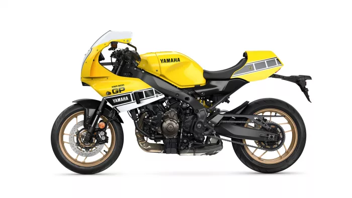 Side view of a bright yellow Yamaha XSR900 GP sport motorcycle with a black frame and gold wheels.