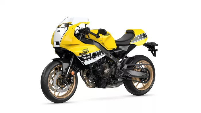 Yellow sport motorcycle shown in a three-quarter front view with gold wheels and racing graphics (Yamaha GP).