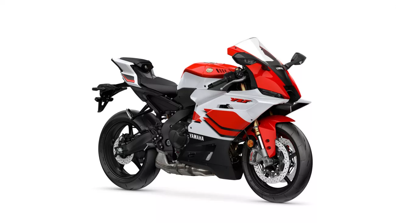 Red, white, and black Yamaha sport motorcycle viewed from the side, showing the fairing and wheel.