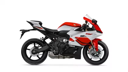 Side view of a red and white Yamaha sport motorcycle on a white background