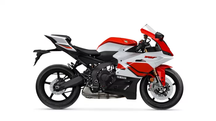 Side view of a red and white Yamaha sport motorcycle on a white background