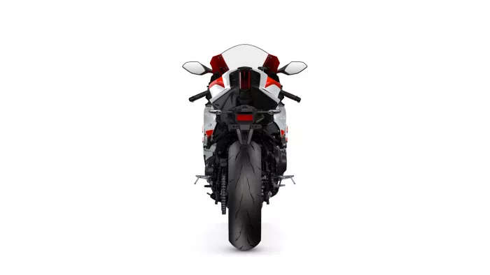 Rear view of a red, white, and black sport motorcycle on a white background.