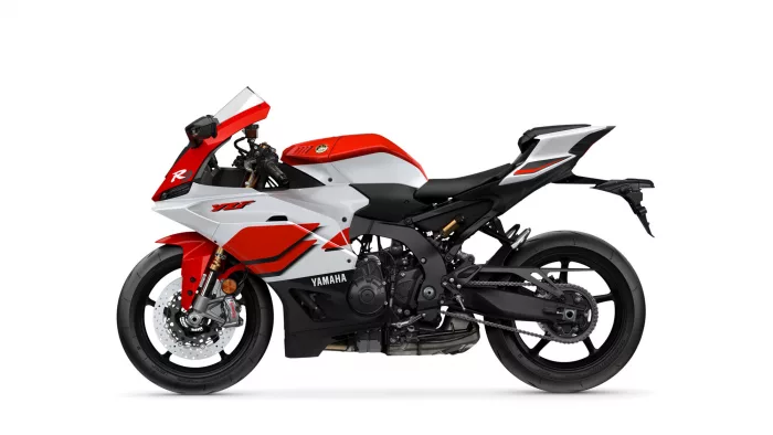 Red and white Yamaha sport motorcycle shown in a left-side profile with visible front disc brake and fairings.